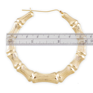 large 10K gold hollow round door knocker bamboo hoop earrings with a 3-inch diameter.