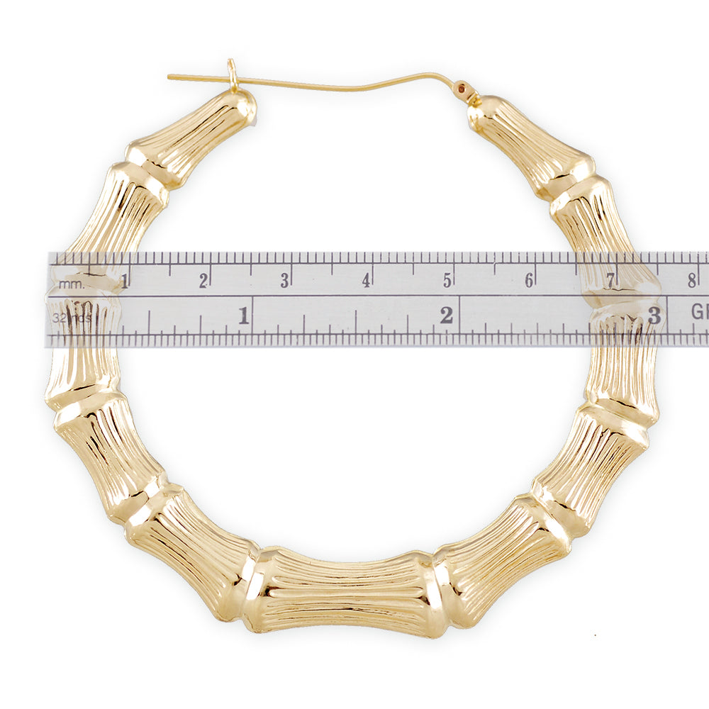 large 10K gold hollow round door knocker bamboo hoop earrings with a 3-inch diameter.