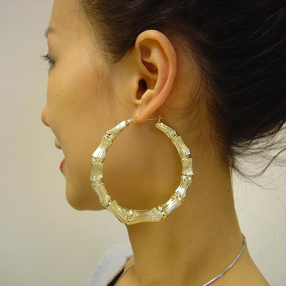 large 3 inches 10K gold hollow round door knocker bamboo hoop earrings on the model.