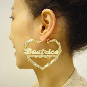 Model wearing large 2.9 inch personalized real gold heart bamboo hoop earrings.