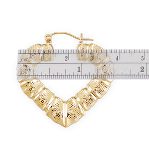 10K yellow gold puffy heart bamboo hoop earrings showing secure clip closure