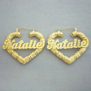 A pair of 10k yellow gold thin heart-shaped bamboo earrings with diamond cut lettering for a personalized name.