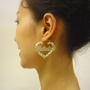 Model wearing 1.6-inch 10k gold personalized heart bamboo nameplate hoop earrings