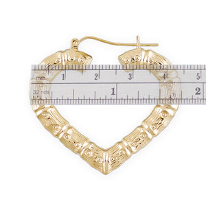 Close-up view of 10K yellow gold heart bamboo hoop earring showing hollow puffed texture and latch closure.