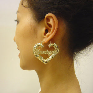 Model wearing 2.18-inch 10k gold personalized puffy heart bamboo hoop earrings