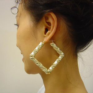 Model wearing 2.75 inch large 10k real gold square door knocker bamboo hoops