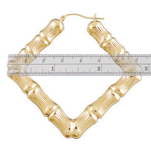 Detail of 10K gold puffed hollow bamboo hoop earring with secure snap closure