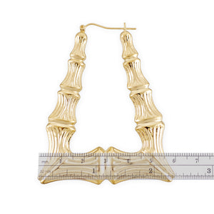Close-up of puffed rectangular bamboo pattern and latch-back clip on 10K gold door knocker earring.