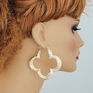 2.5 inch 10K gold flower bamboo door knocker hoop earrings on mannequin.