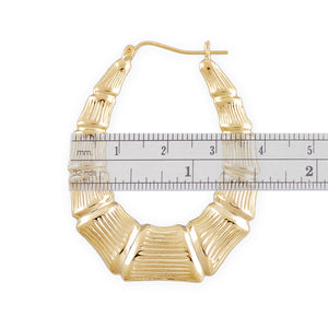 Close-up of 10K Yellow Gold Oval Bamboo Earring showing textured detail and snap back closure