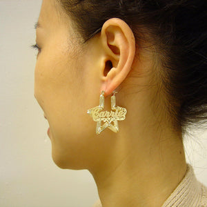 Model wearing 1.38 inch 10K gold star bamboo personalized name hoop earrings