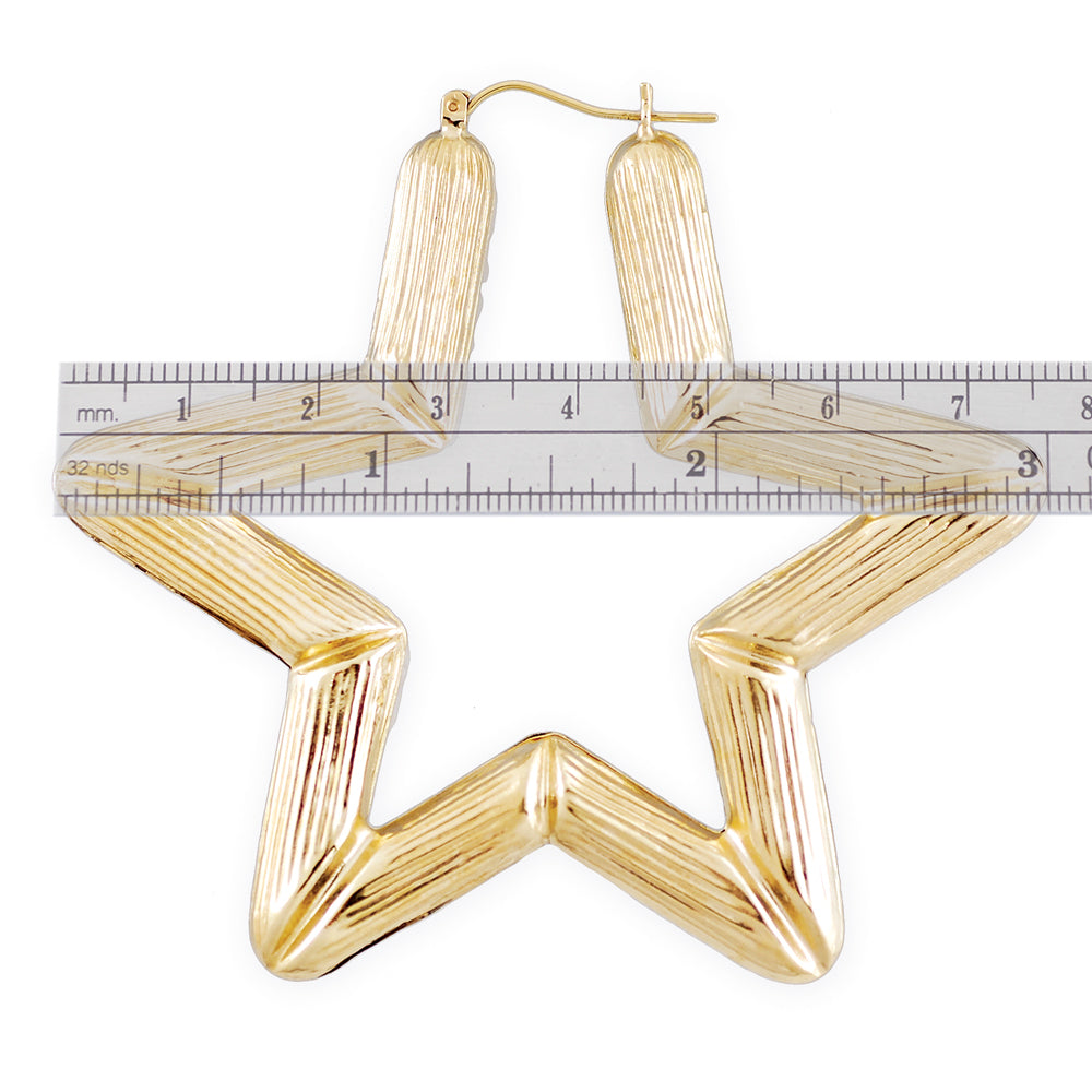 Close-up of puffed hollow 10K yellow gold star bamboo earring design