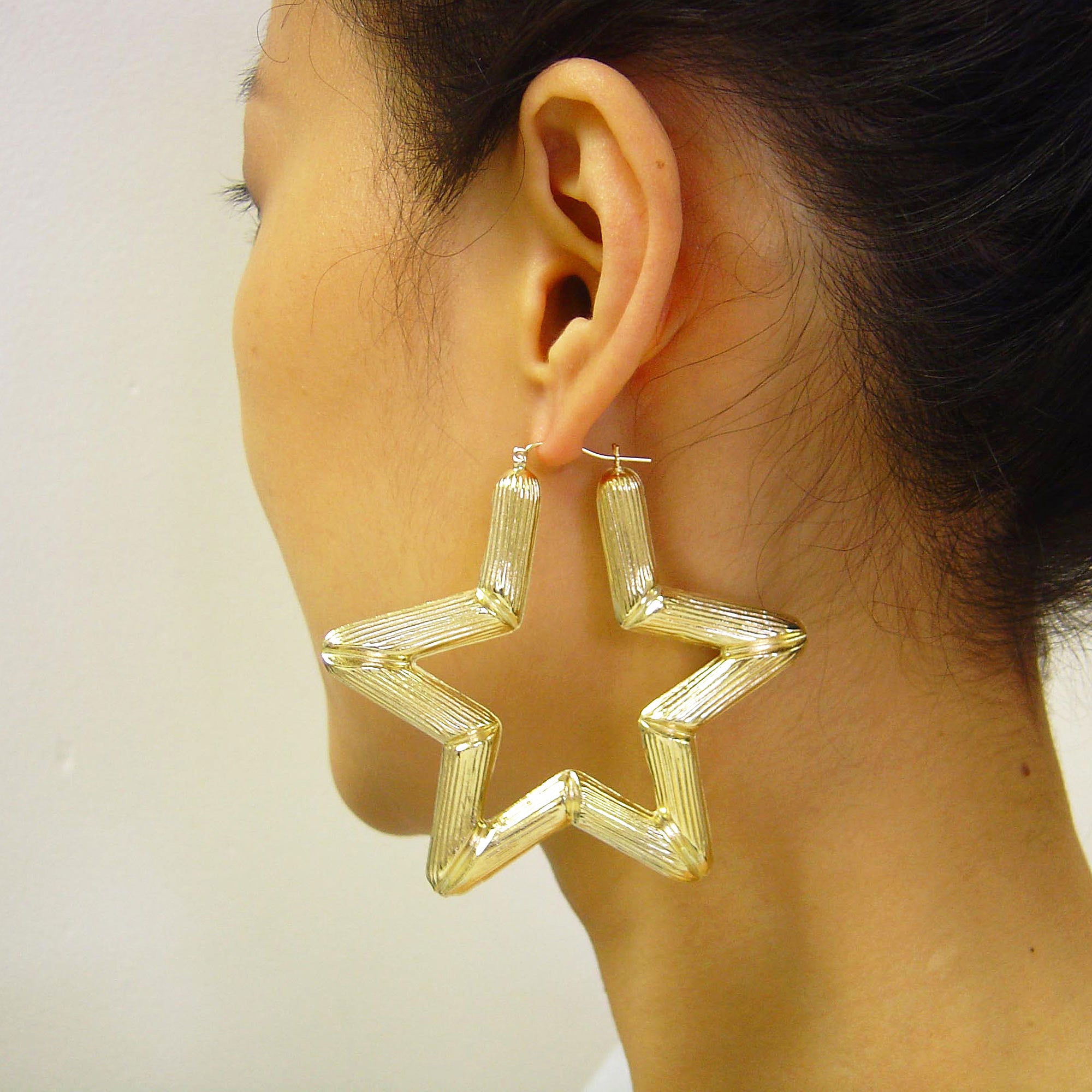 3-inch 10K yellow gold star bamboo door knocker earrings shown for size reference