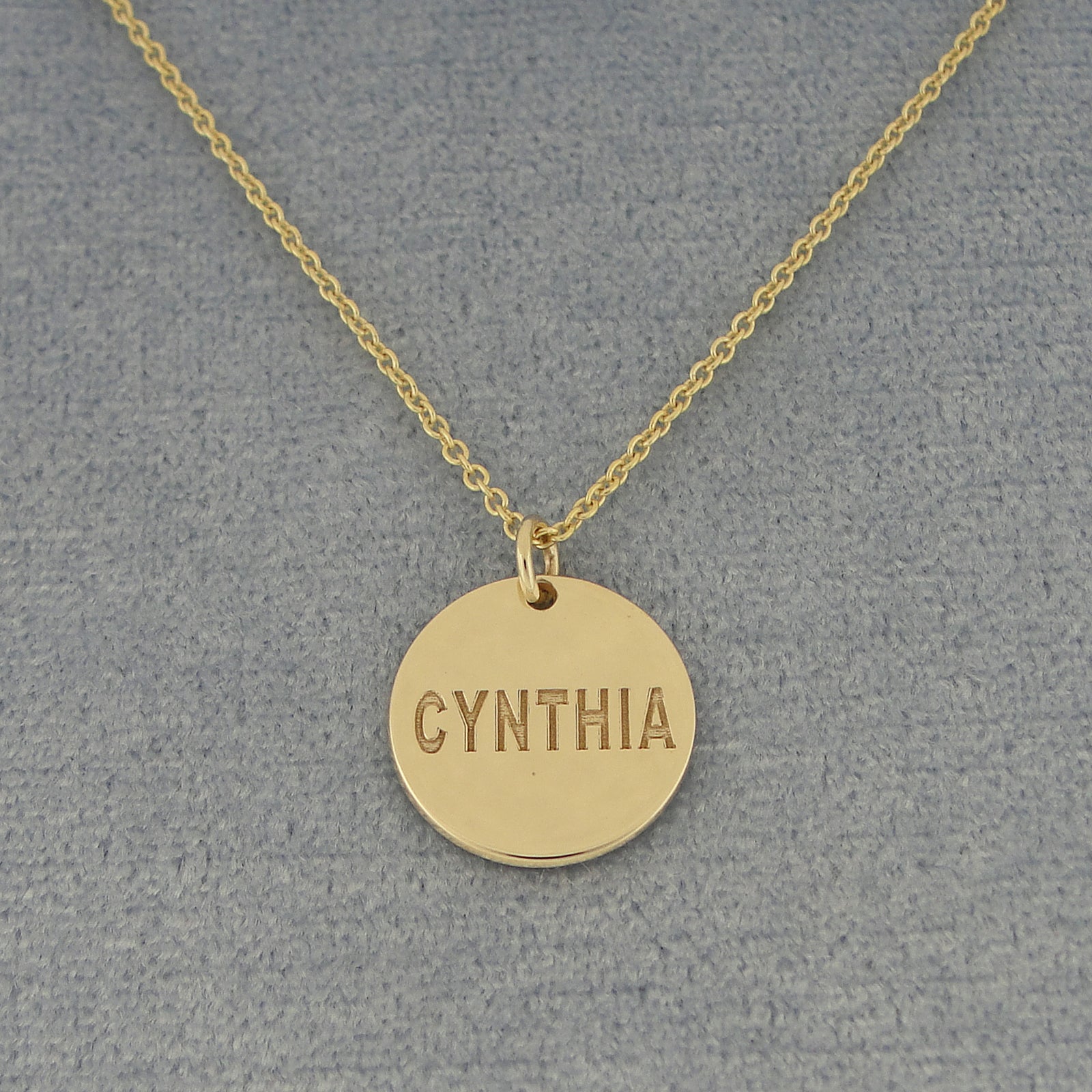 Solid gold personalized name disc charm pendant with a deep laser engraved