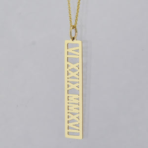 Custom solid gold vertical bar pendant laser-engraved with Roman numerals.