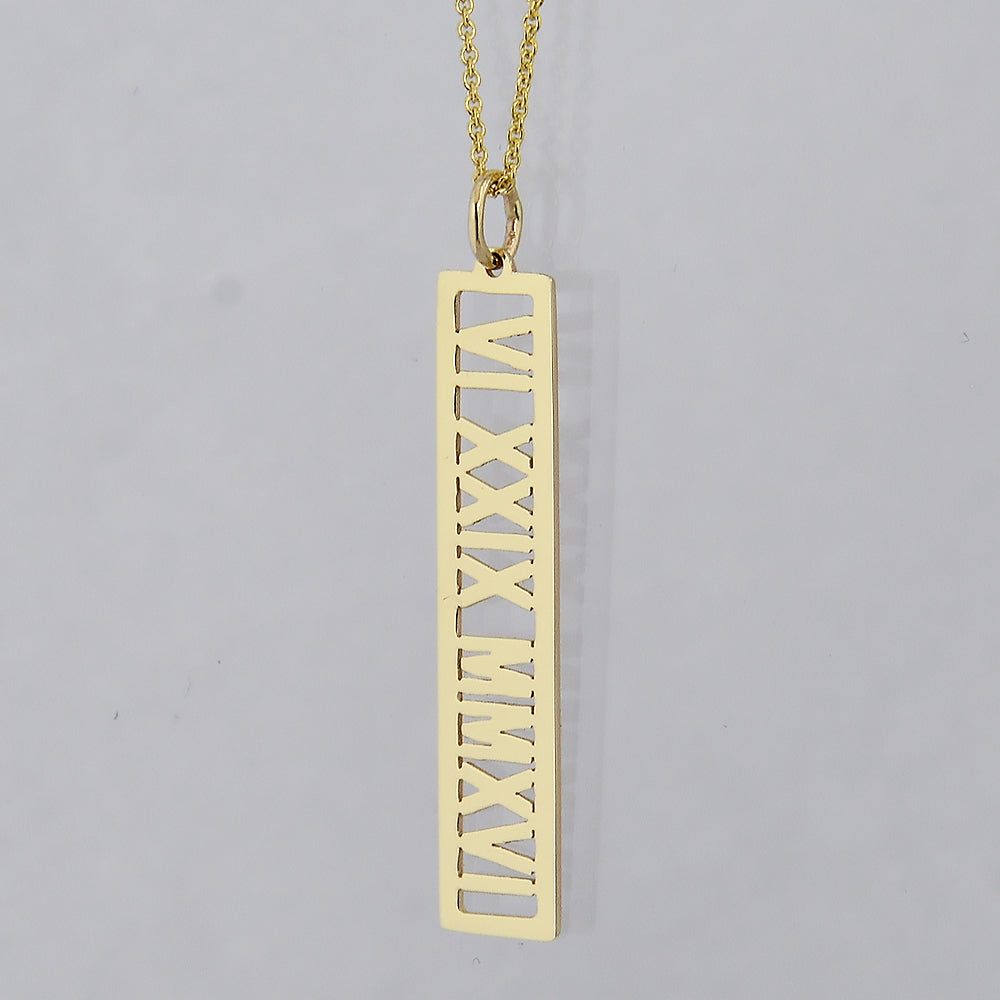 Custom solid gold vertical bar pendant laser-engraved with Roman numerals.