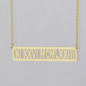 Custom 14k yellow gold horizontal bar necklace engraved with Roman numeral date XI XXVI MCMLXXIII
