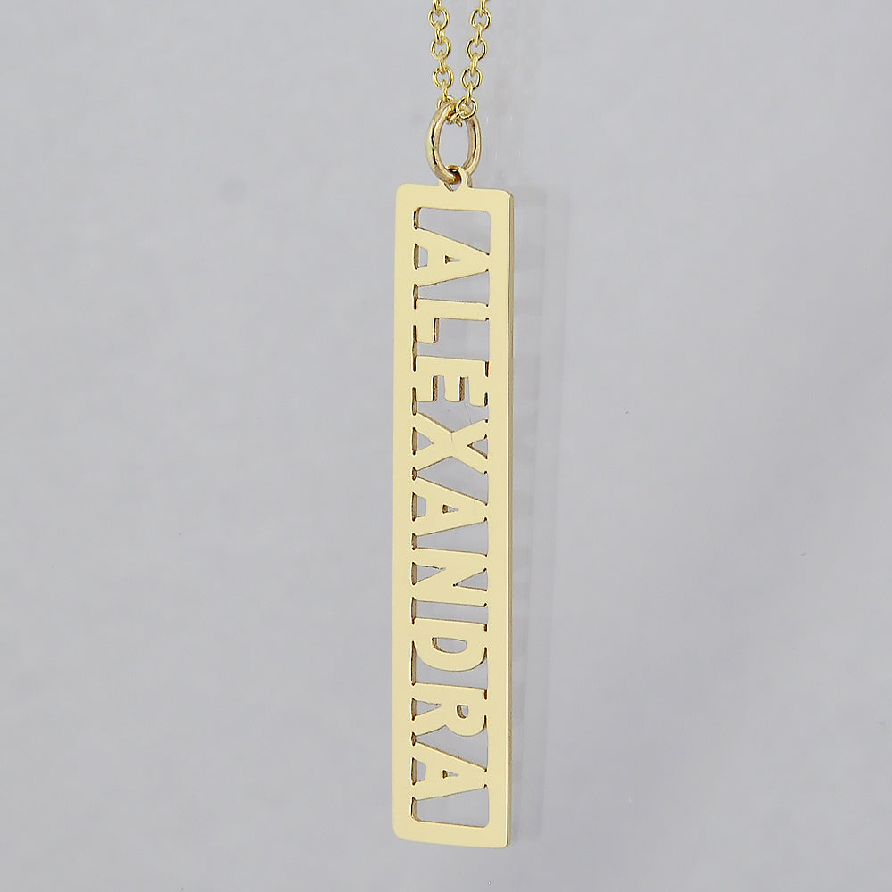 Custom 14k yellow gold vertical bar pendant necklace personalized with the name Alexandra