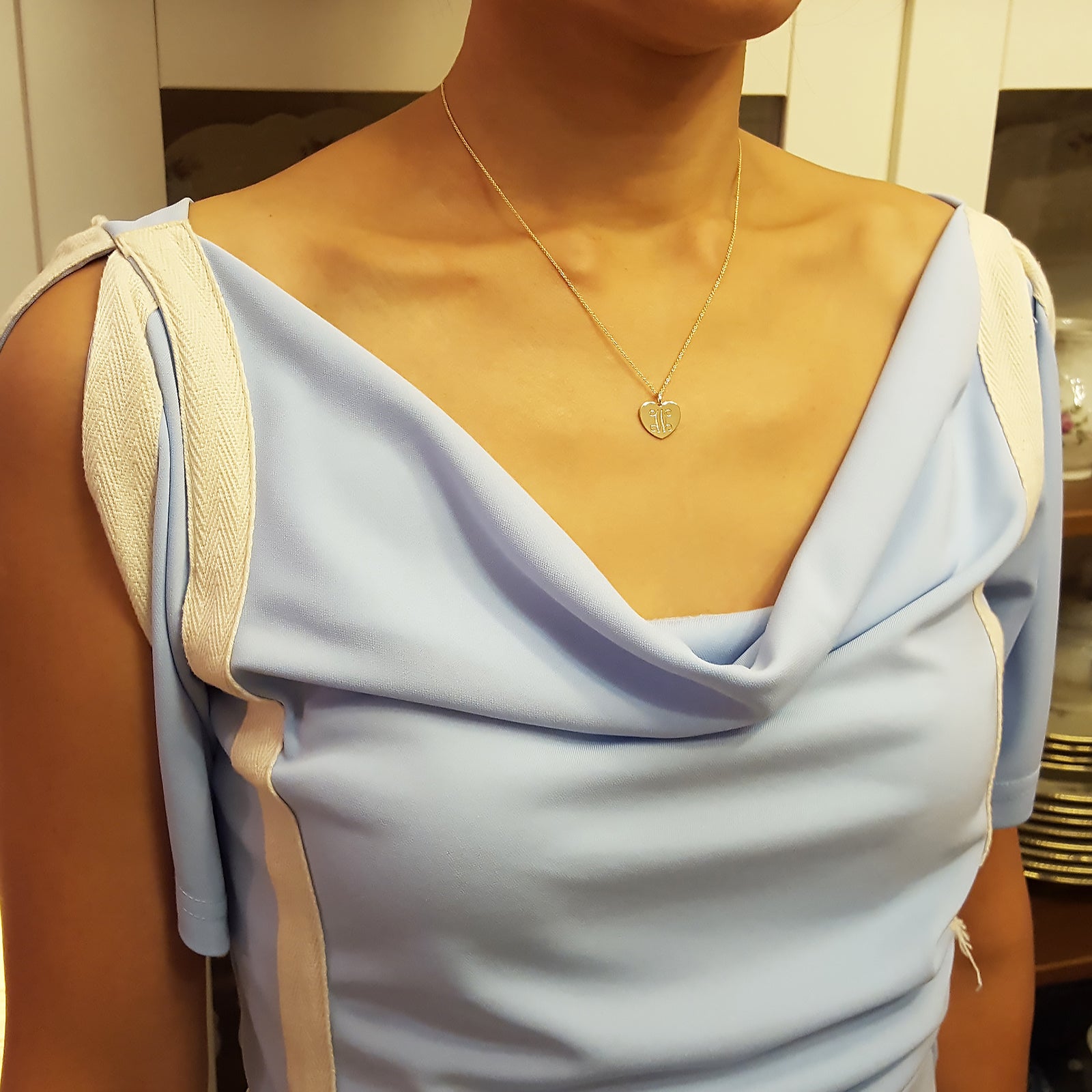 Model wearing custom 3 initial heart monogram gold necklace in 14k yellow gold
