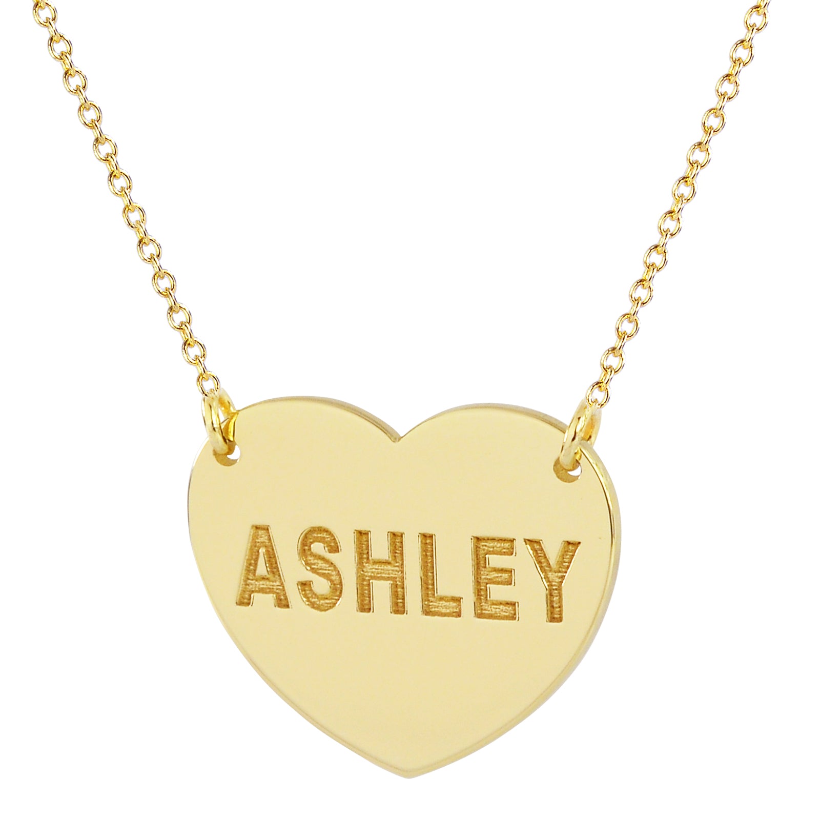 A gold heart-shaped pendant necklace engraved with the name 'ASHLEY' in raised capital letters, suspended from a delicate gold chain against a plain white background.