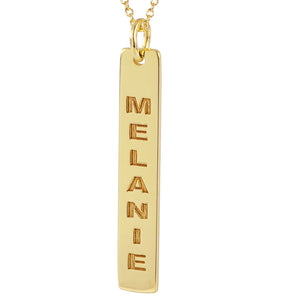 High-polish 14k yellow gold vertical bar pendant showing precision laser-cut engraving