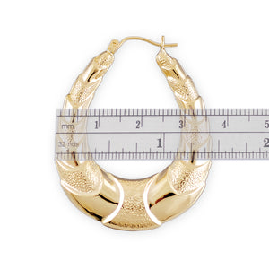 Textured 10K yellow gold puffed shrimp door knocker earring detail with snap closure