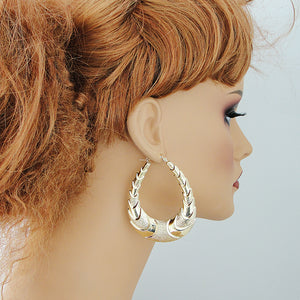 wearing 10K solid gold large oval shrimp door knocker earrings (2.1" wide)