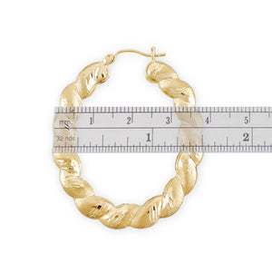 Close-up of diamond-cut texture on 10K solid gold oval hoop earring