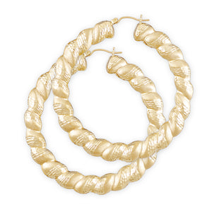 A pair of 10k yellow gold twisted round diamond cut hollow earrings with secure clip enclosures.