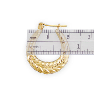 Close-up of textured wheat pattern on 10K yellow gold baby doorknocker hoop earrings
