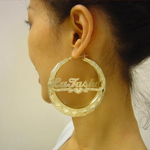 Close-up of custom cursive lettering and diamond-cut heart detail on 2.9 inch 10k gold name hoop earring