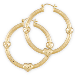 A pair of 10k gold hollow puffy heart-shaped doorknocker earrings with diamond cuts.