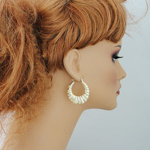1.3 inch wide 10K gold diamond cut shrimp door knocker earrings on model