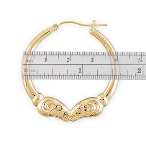 Close-up of high polish finish and intricate ram head detail on 10k solid gold hoop earrings