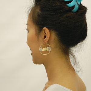Model wearing personalized 14k gold 1.5 inch butterfly name hoop earrings