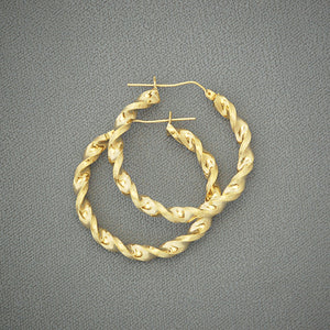 Close-up view of 10K yellow gold 4mm twisted hoop earring texture and shine