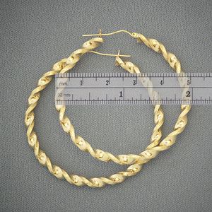 Close-up of 4mm twisted hollow design and snap closure on 10K gold hoop earring