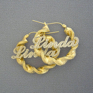 Custom 10k real gold iced out name hoop earrings featuring 6mm twisted design and two-tone diamond-cut finish with custom nameplate.