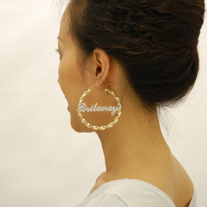 Model wearing 2.75 inch large 10k gold personalized iced out name hoop earrings