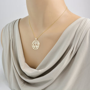 Personalized 14k yellow gold 3 letter monogram necklace worn on mannequin