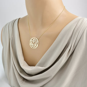1.25-inch custom gold circle monogram necklace showcasing traditional 3-initials on mannequin