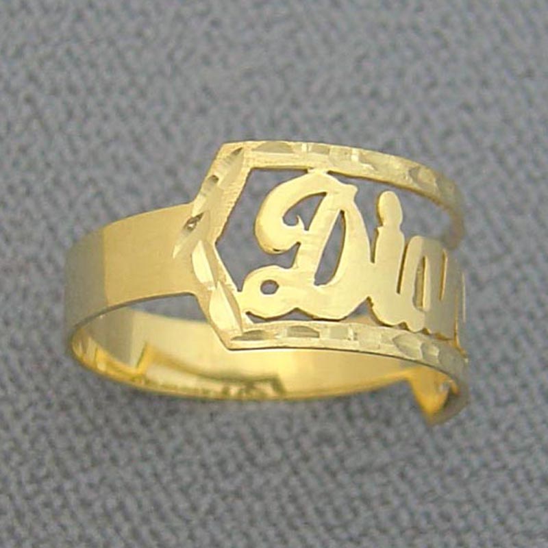 Angled side view of custom solid gold cursive script name ring