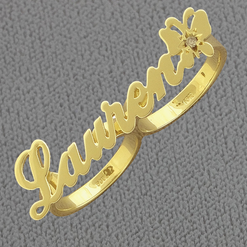 Detail view of custom solid gold script lettering on 2-finger butterfly diamond ring