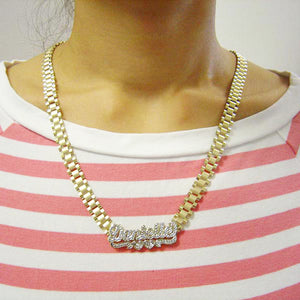 Model wearing a custom 10K gold iced out name necklace with an 8mm watch-band style chain