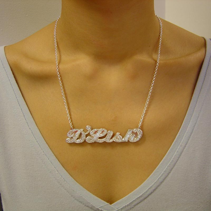 Model wearing a large personalized 3D sterling silver double name plate necklace with diamond accents.