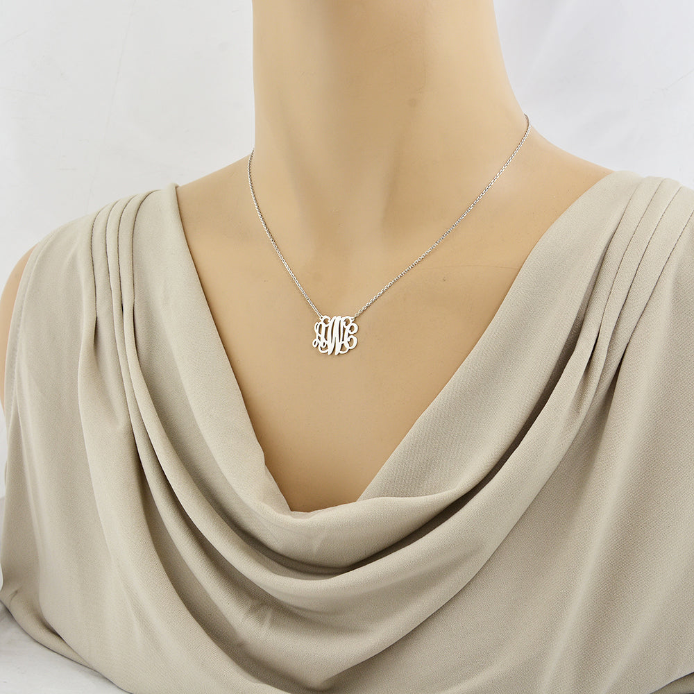 Model wearing custom sterling silver 3-initial monogram pendant necklace