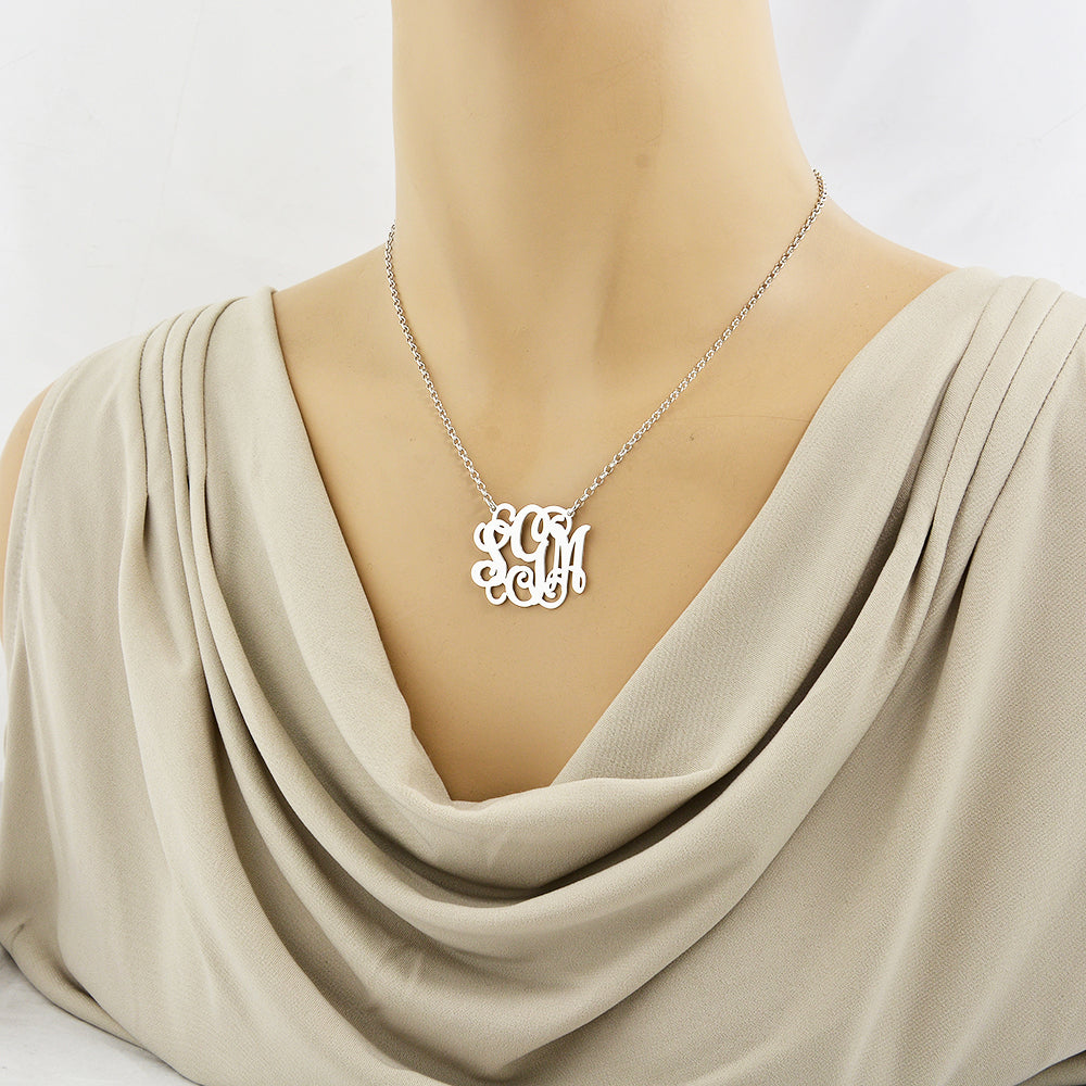 Woman wearing 1.25-inch sterling silver 3-initial script monogram pendant necklace on a 16-inch chain