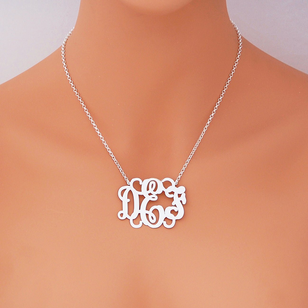 Woman wearing personalized 1.75 inch sterling silver 3-letter monogram necklace