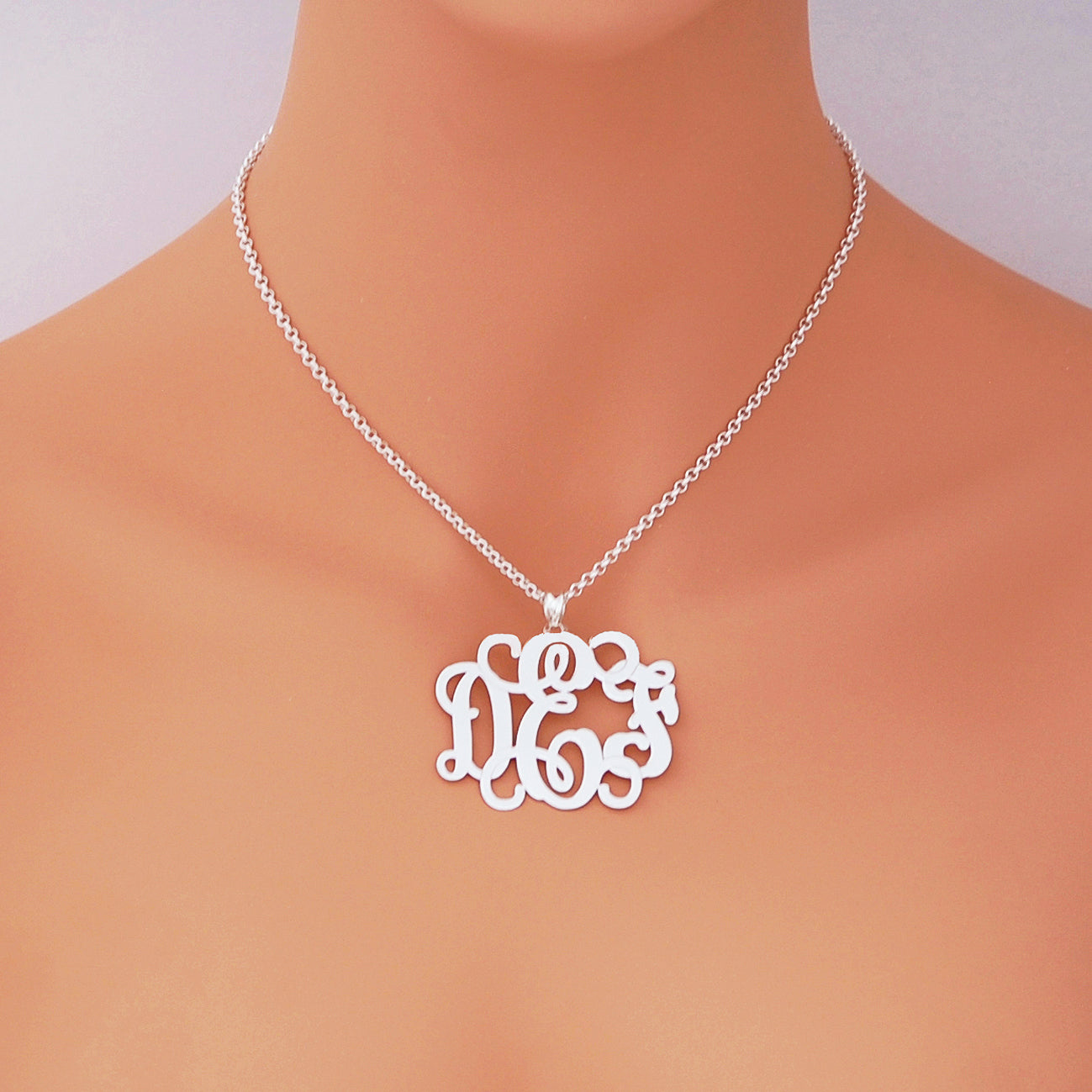 Model wearing the personalized 1.75-inch sterling silver 3-initial monogram necklace on a silver chain.