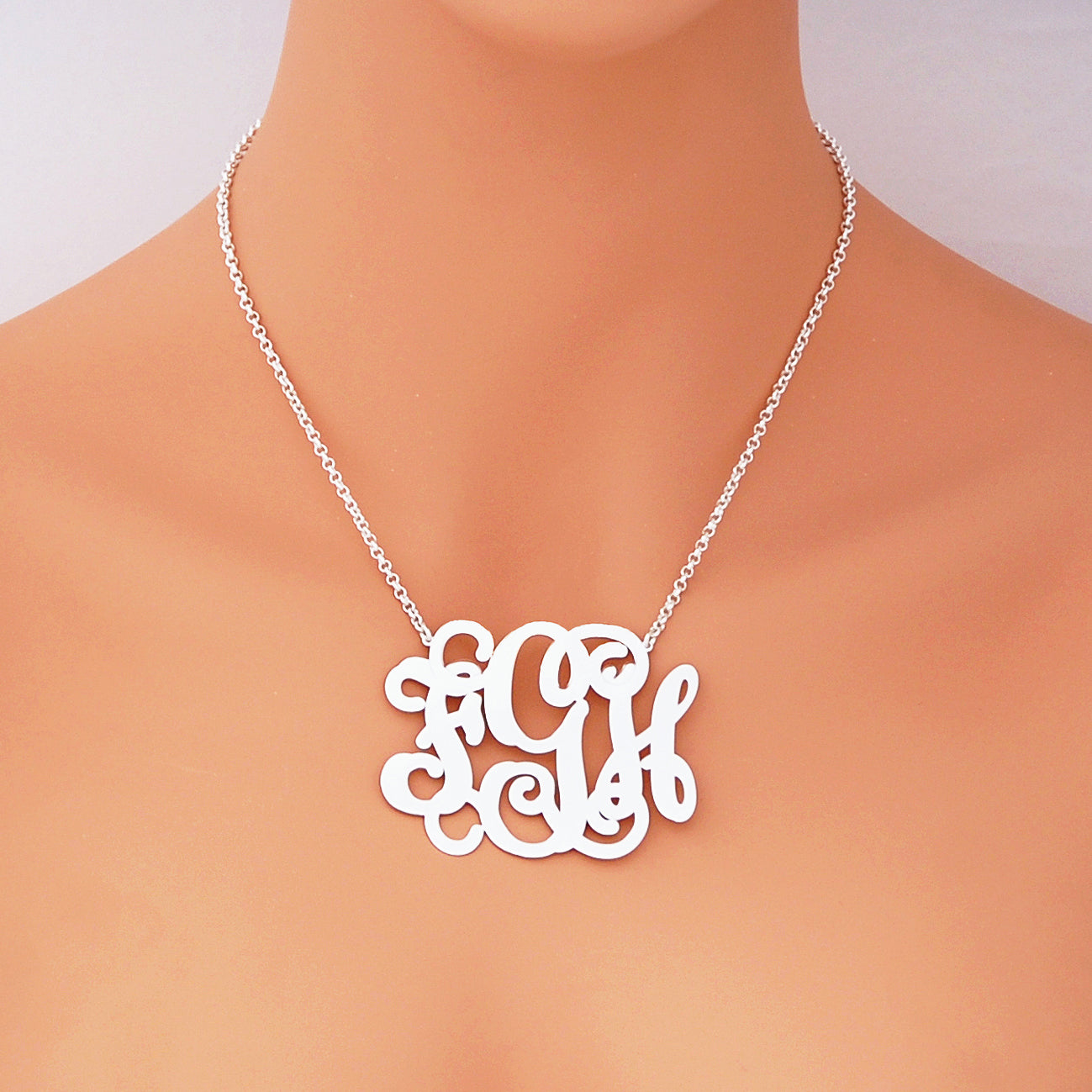 Woman wearing 2.5-inch custom sterling silver monogram necklace